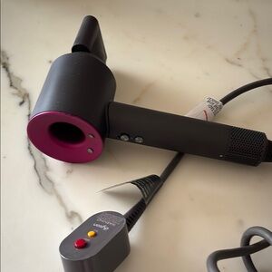 Dyson Hair Dryer in dark gray and pink